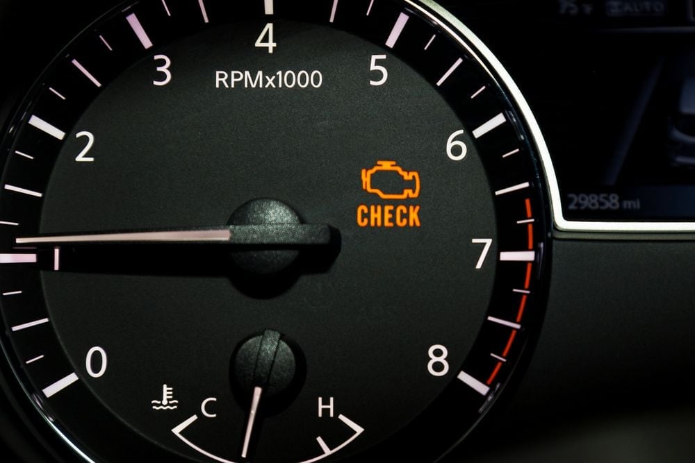 A vehicle dash displaying a check engine light.