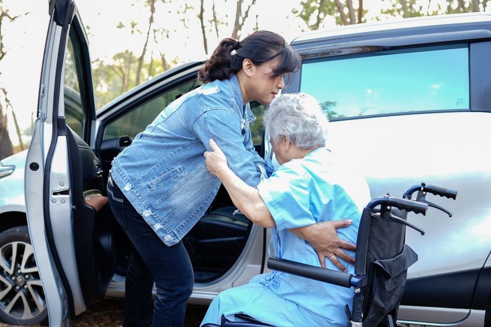 helping_elderly_person_in_wheelchair_into_vehicle_shutterstock_1623023371