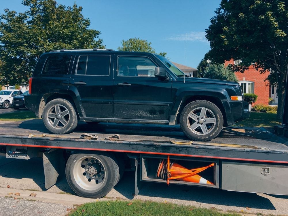 jeep_on_back_of_tow_truck_shutterstock_1345427201