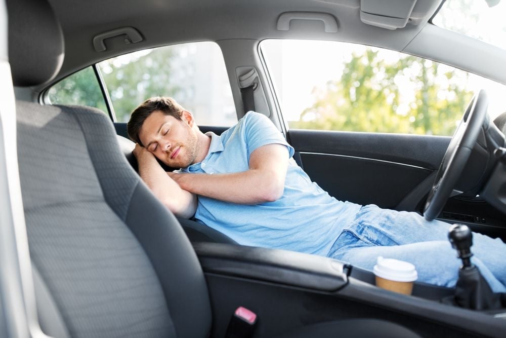 You are at virtually no risk of suffucation when sleeping in a car that is not running.