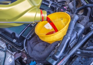mechanic_filling_a_transmission_with_transmission_fluid_shutterstock_683137843