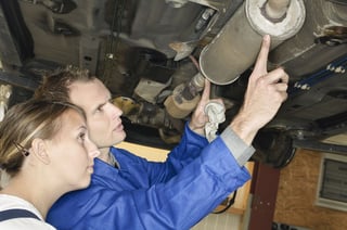 mechanics_preparing_to_remove_a_muffler_for_a_muffler_delete_shutterstock_67247659