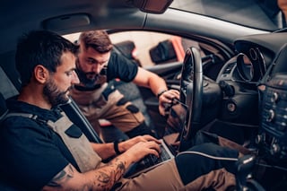 two_mechanics_tuning_a_car_shutterstock_1720359490