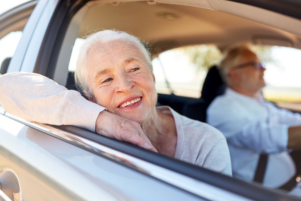 Elderly Woman enjoying her car ride.