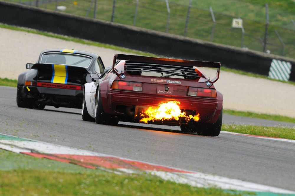 Flames exiting exhaust due to a backfire.