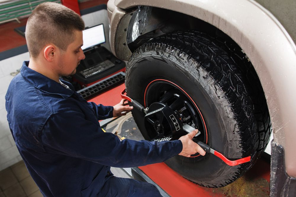 Mechanic checking tire alignment