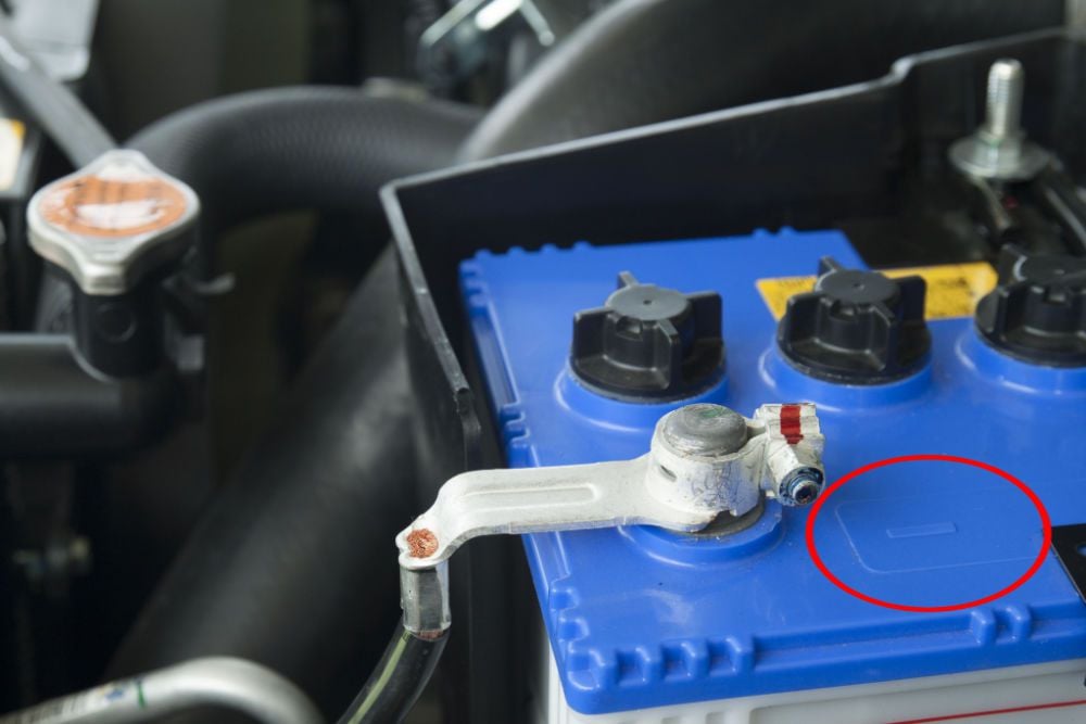 The negative battery terminal on a car battery.
