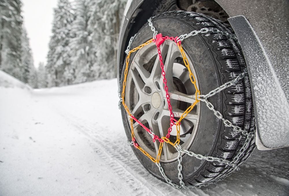 Snow chain installed on front driver side tire.